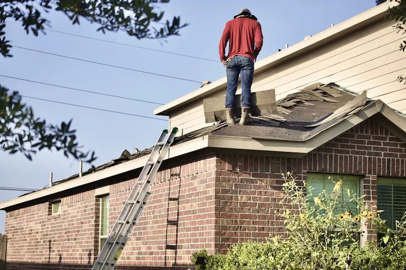 Professional roofer working on a residential roof in Downtown Fontana